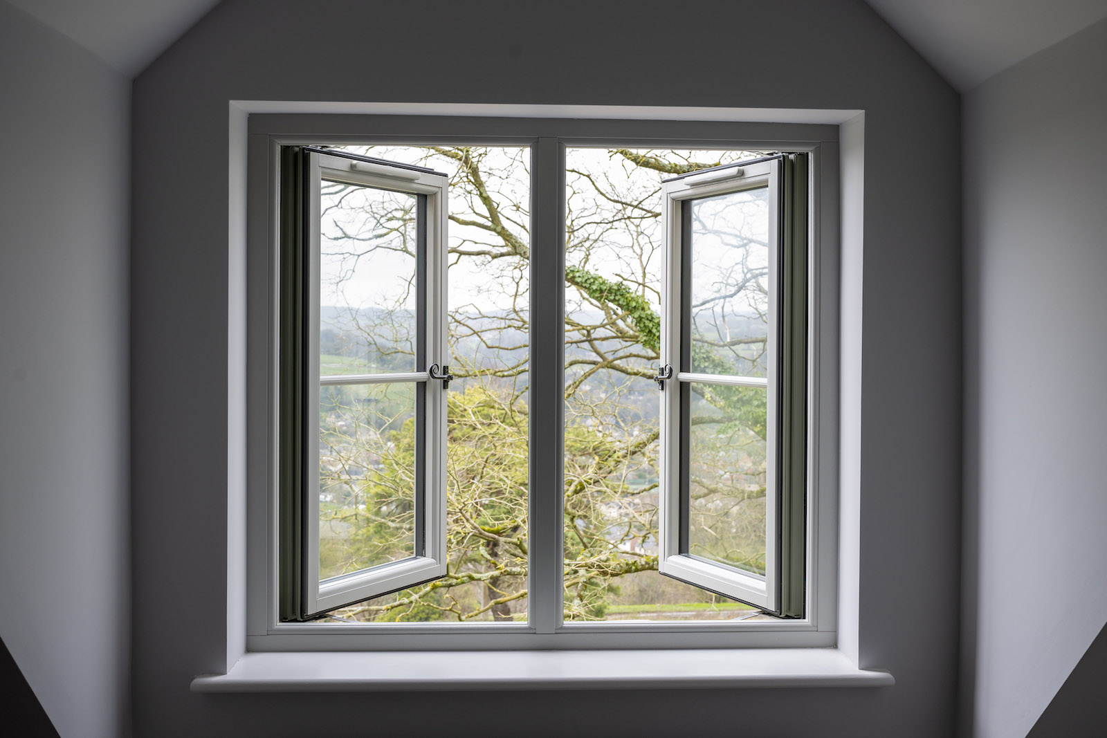Open double window with countryside view